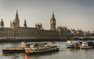 The Houses of Parliament in London with the River Thames in front with boats on