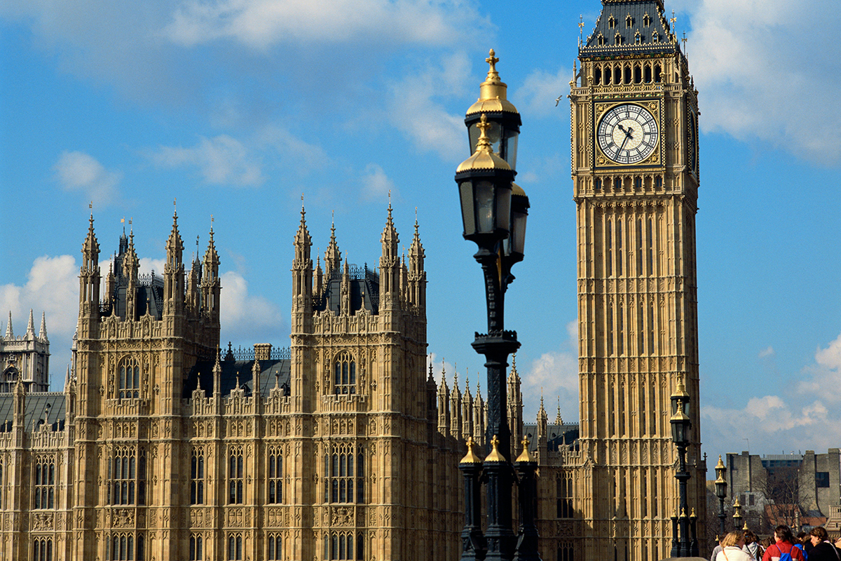 A view of the Houses of Parliament with a blue sky behind