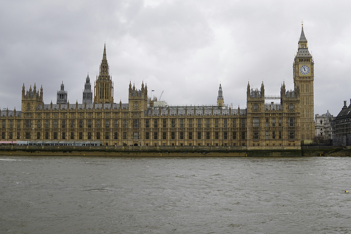 The Houses of Parliament with the River Thames in front on a cloudy day